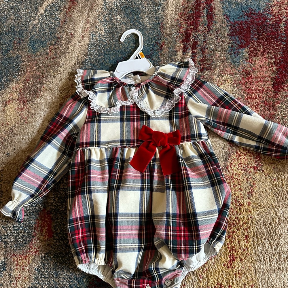 Beautiful tartan romper with velvet red bow.